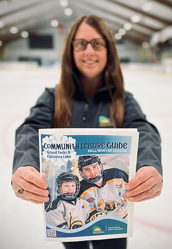Melina holding the GF Rec community Leisure guide